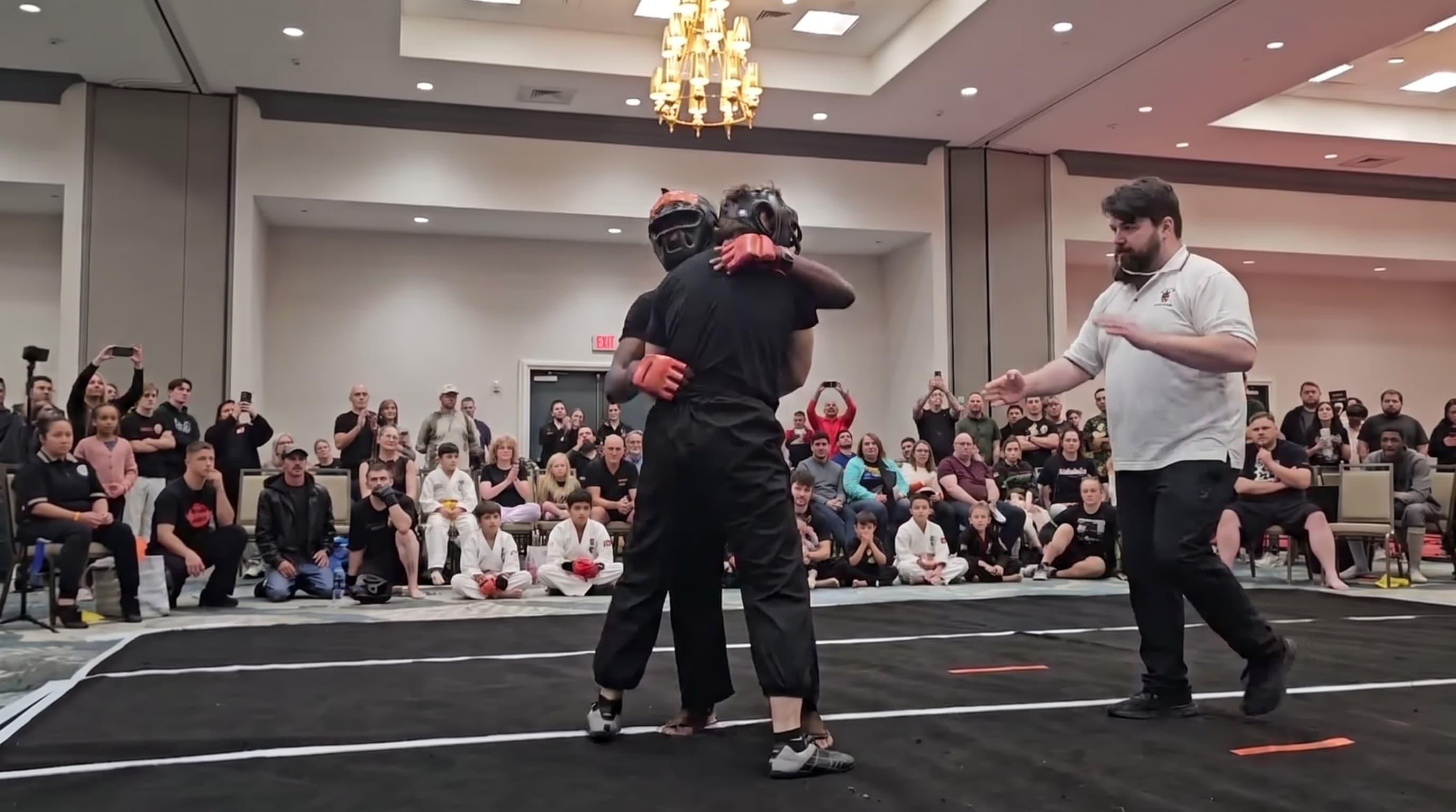 Cloud Forest students sparring in protective headgear in front of spectators
